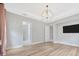 Spacious main bedroom with luxury vinyl plank flooring and a chandelier at 4551 Barletta Ct, Wesley Chapel, FL 33543