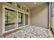 Screened-in patio with brick floors and large windows overlooking greenery at 4551 Barletta Ct, Wesley Chapel, FL 33543