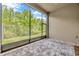 A screened patio has tile floors and a view of the green space and trees at 4551 Barletta Ct, Wesley Chapel, FL 33543