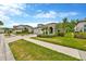 Well-manicured front lawns and inviting curb appeal featuring beautiful landscaping and paved driveways at 4551 Barletta Ct, Wesley Chapel, FL 33543