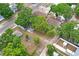 Aerial view showcasing the property, surrounded by lush trees and neighboring homes at 5042 8Th St, Zephyrhills, FL 33542