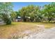 Spacious backyard featuring mature trees, a shed, and room to roam at 5042 8Th St, Zephyrhills, FL 33542