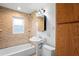 Updated bathroom with custom tiled shower and pedestal sink at 5042 8Th St, Zephyrhills, FL 33542
