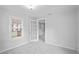 Bedroom with neutral colors, lots of light and a glass paned door at 5042 8Th St, Zephyrhills, FL 33542