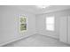 Bedroom with new carpet and dual windows at 5042 8Th St, Zephyrhills, FL 33542