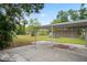 Carport features a concrete slab with a covered metal awning frame at 5042 8Th St, Zephyrhills, FL 33542