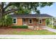 Charming single-story home with covered porch, mature trees, and a cozy, inviting curb appeal at 5042 8Th St, Zephyrhills, FL 33542