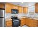 Kitchen with wood cabinets, updated stainless steel appliances, and lots of counter space at 5042 8Th St, Zephyrhills, FL 33542