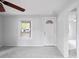 Bright living room with fresh paint, new carpeting, a ceiling fan, and ample natural light at 5042 8Th St, Zephyrhills, FL 33542