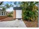Exterior shot of backyard shed with painted siding and concrete path at 5042 8Th St, Zephyrhills, FL 33542