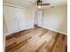 Bedroom with hardwood floors, a ceiling fan, and a double door closet at 6046 7Th Ave, New Port Richey, FL 34653