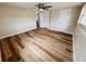 Bedroom with neutral walls, a ceiling fan, wood-look floors, and double closets at 6046 7Th Ave, New Port Richey, FL 34653