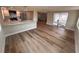 Open-concept living room and kitchen area with hardwood flooring and sliding glass doors at 6046 7Th Ave, New Port Richey, FL 34653