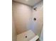 Bathroom with a modern, tiled walk-in shower with a rainfall showerhead and new fixtures at 6046 7Th Ave, New Port Richey, FL 34653
