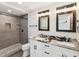 Upgraded bathroom with dual vanities, granite countertops, and a stone pebble shower floor at 6436 2Nd S Ave, St Petersburg, FL 33707