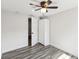 This bedroom features wood-look flooring, a ceiling fan, and a closet for storage at 6436 2Nd S Ave, St Petersburg, FL 33707
