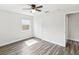 A bright bedroom features two windows, wood-look flooring, and a ceiling fan at 6436 2Nd S Ave, St Petersburg, FL 33707