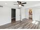 Spacious bedroom showcasing wood-look floors, ceiling fan, and access to the bathroom at 6436 2Nd S Ave, St Petersburg, FL 33707