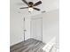 Bright bedroom featuring wood floors, a ceiling fan, and a double closet at 6436 2Nd S Ave, St Petersburg, FL 33707