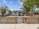 The charming single-story home features a fenced front yard and light gray siding with dark gray roof at 6436 2Nd S Ave, St Petersburg, FL 33707