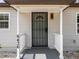 Charming front door with black security gate and white porch columns at house number 6436 at 6436 2Nd S Ave, St Petersburg, FL 33707