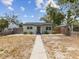 Charming home with a well-maintained lawn, inviting walkway, and light gray siding at 6436 2Nd S Ave, St Petersburg, FL 33707