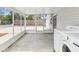This outdoor laundry area leads to a screened in porch with an attached garage at 6436 2Nd S Ave, St Petersburg, FL 33707
