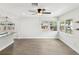 Spacious living area with hardwood floors, large windows, and open access to the stylish kitchen at 6436 2Nd S Ave, St Petersburg, FL 33707