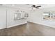 Bright and airy living room with modern flooring, large windows, and kitchen pass-through at 6436 2Nd S Ave, St Petersburg, FL 33707