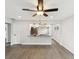 Open-concept living area featuring modern flooring, ceiling fan and a view into the updated kitchen at 6436 2Nd S Ave, St Petersburg, FL 33707