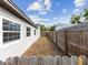 This side yard has a wooden fence, trimmed lawn, and plenty of light at 6436 2Nd S Ave, St Petersburg, FL 33707
