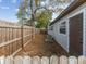 Side yard features a wooden fence, lush greenery, and an AC unit outside of the home at 6436 2Nd S Ave, St Petersburg, FL 33707