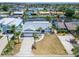Aerial view of home showcasing canal front location, mature trees, and attached two-car garage at 743 Kingston Ct, Apollo Beach, FL 33572