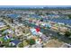 Aerial view of a waterfront property situated among canals and neighborhood houses, featuring mature trees at 743 Kingston Ct, Apollo Beach, FL 33572