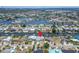 Aerial view of a waterfront property with boat docks, palms, a canal, and surrounding homes at 743 Kingston Ct, Apollo Beach, FL 33572