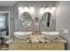 Bathroom with double sink vanity, granite countertop, oval mirrors, and modern fixtures with decorative lighting at 743 Kingston Ct, Apollo Beach, FL 33572