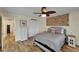 A well lit bedroom with a large bed, wood-look floors, decorative wall art, and storage options at 743 Kingston Ct, Apollo Beach, FL 33572