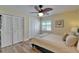 Inviting bedroom with a ceiling fan, wood-look floors, plantation shutters, and double closets for ample storage at 743 Kingston Ct, Apollo Beach, FL 33572