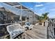 Inviting waterfront deck featuring white wicker seating, overlooking a pool and canal at 743 Kingston Ct, Apollo Beach, FL 33572