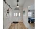 A well-lit foyer featuring a barn door, wood-look flooring, and views of a living area with nautical decor at 743 Kingston Ct, Apollo Beach, FL 33572