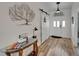 A foyer featuring a barn door, a wood-look floor, an entry door with sidelights, and a decorative tree art piece at 743 Kingston Ct, Apollo Beach, FL 33572