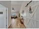 An inviting foyer featuring wood-look flooring, white walls, a sliding barn door, and views into the living room at 743 Kingston Ct, Apollo Beach, FL 33572
