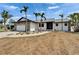 One-story home showcasing a stone facade garage, tropical landscaping, and walkway to the front entrance at 743 Kingston Ct, Apollo Beach, FL 33572