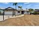 A quaint, single-story home with an attached garage, stone facade, and tropical landscaping at 743 Kingston Ct, Apollo Beach, FL 33572
