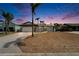 Charming single-story home with stone accents, mature palms, and a long driveway at dusk at 743 Kingston Ct, Apollo Beach, FL 33572