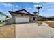 A single-story home featuring a stone facade garage and extra-wide driveway at 743 Kingston Ct, Apollo Beach, FL 33572