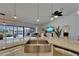Kitchen view with island, a view into the living room, and view of outdoor pool beyond sliding glass door at 743 Kingston Ct, Apollo Beach, FL 33572