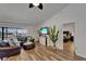 Spacious living room with wood flooring, a leather sectional, and a view of the outdoor pool at 743 Kingston Ct, Apollo Beach, FL 33572