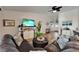 Cozy living room area with a leather sectional, wood floors, and an entertainment center at 743 Kingston Ct, Apollo Beach, FL 33572