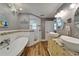 The elegant bathroom features a soaking tub, granite countertops, and a walk-in shower at 743 Kingston Ct, Apollo Beach, FL 33572
